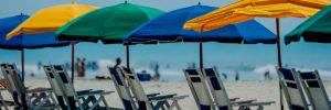 multiple beach umbrellas with chairs